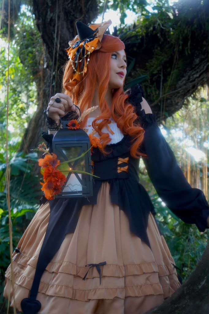 Halloween witch character holding a lantern in the garden