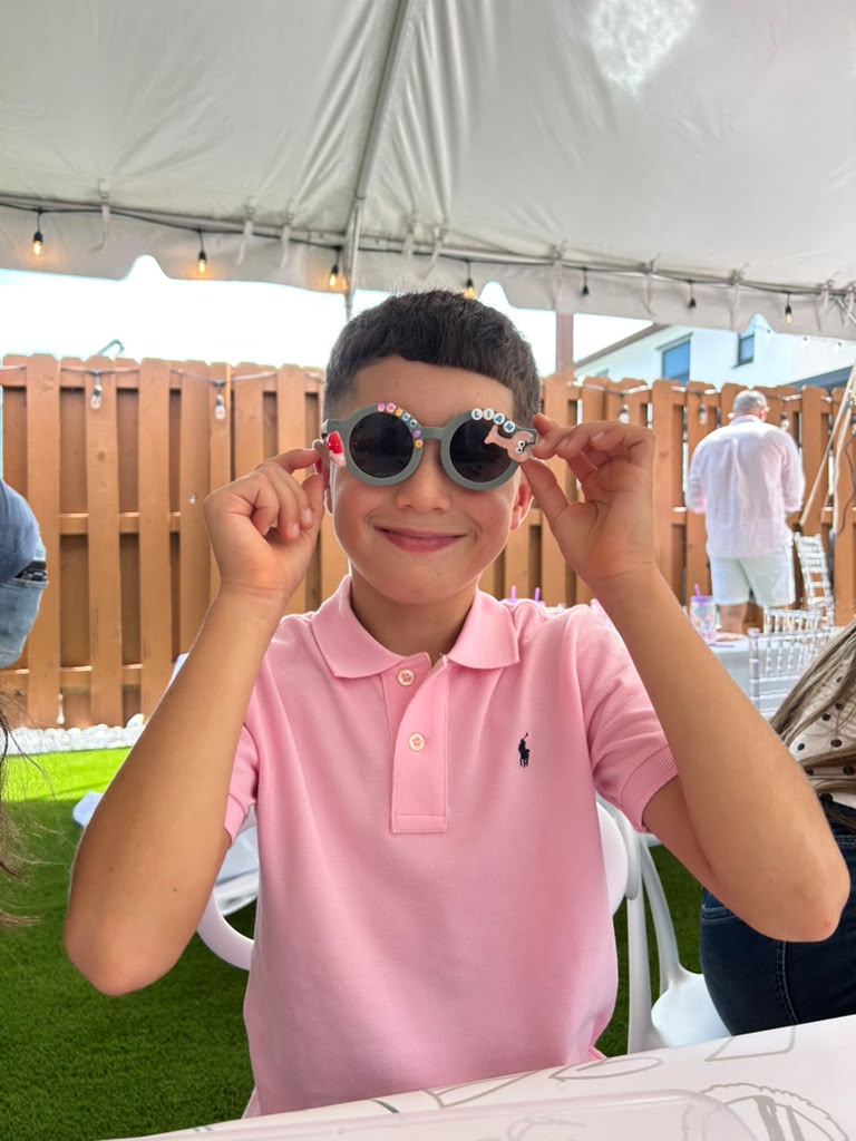 Birthday kid showing off his decorated sunglasses