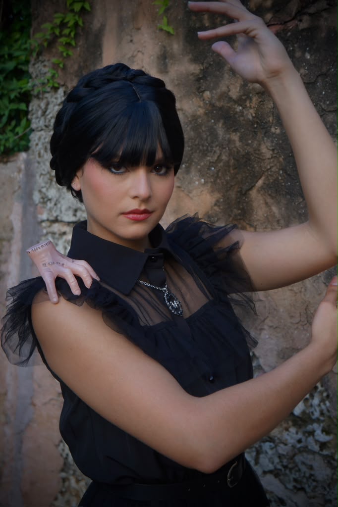 Spooky season character posing by a stone wall