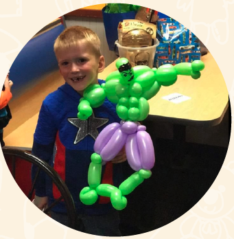 Kid holding a balloon art creation