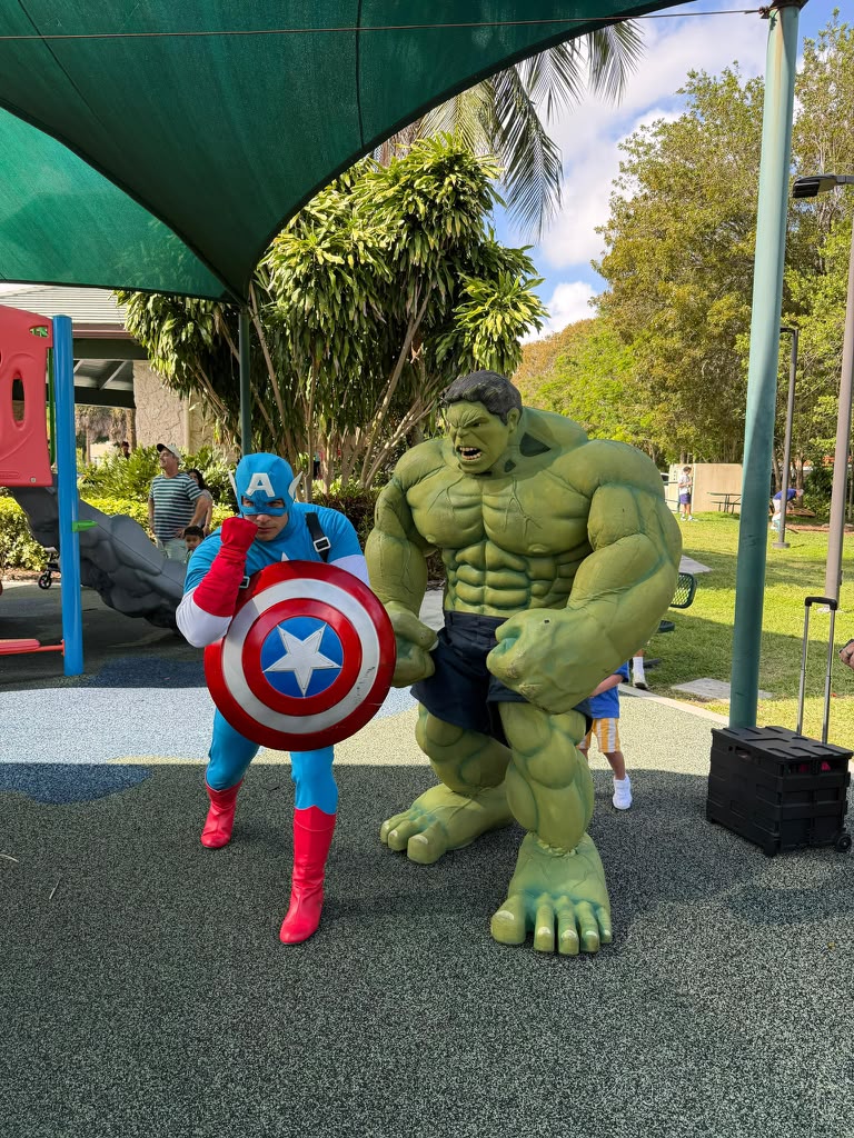 Captain America and Hulk characters posing together at a playground