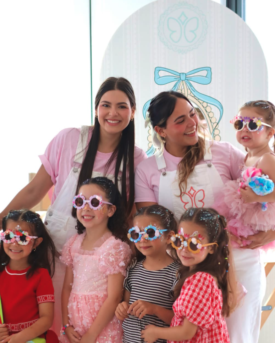 Kids wearing handmade flower sunglasses with two party hosts