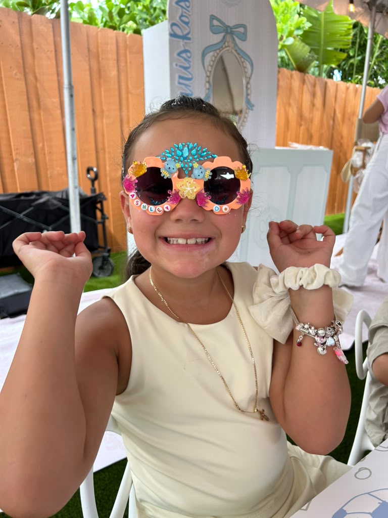 Birthday girl showing off her decorated sunglasses