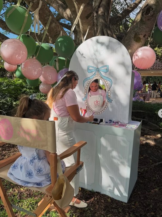 Creative Corner painting station with a kid and an artist
