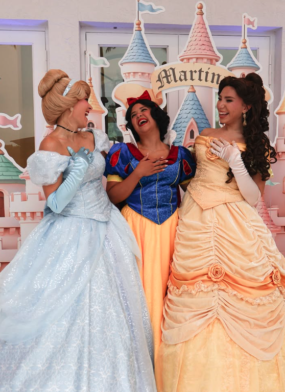 Three princess characters laughing together at a party