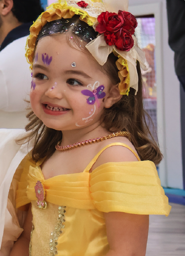 Kid with princess makeup, gems and hairstyle