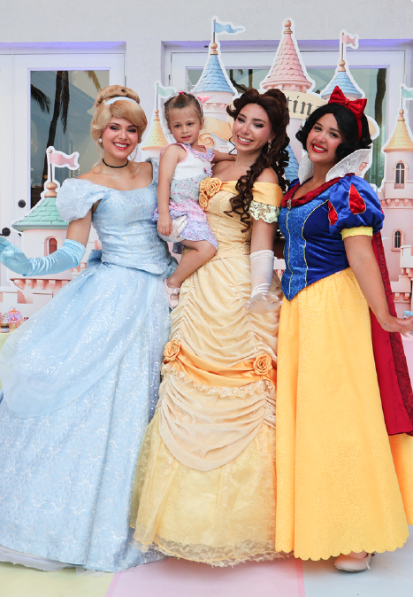 Three princess characters holding a birthday girl