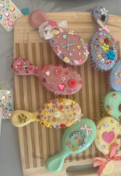 Hair brushes decorated with charms and gems