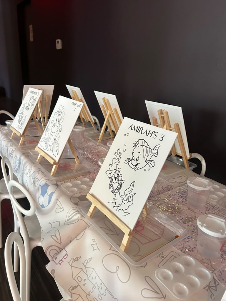 Personalized mermaid canvases on easels ready to paint