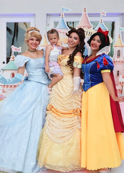 Three classic princess characters holding a birthday girl
