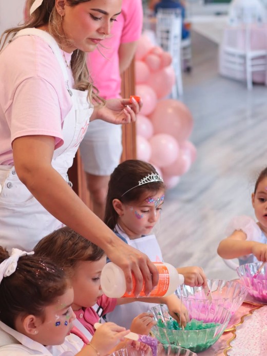 Kids mixing colorful slime at the craft table