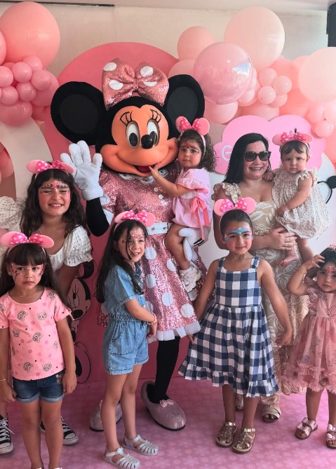 Mouse mascot with a group of face painted kids