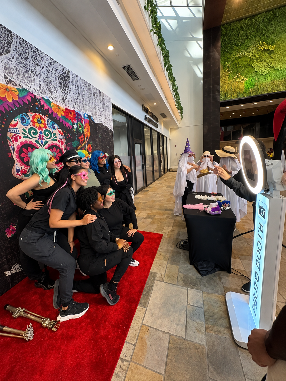 Group posing with props in front of the digital photo booth