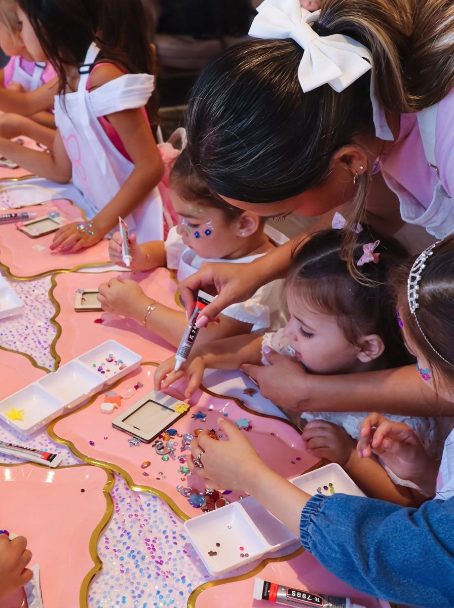 Creative Corner hosts in branded aprons ready to guide kids' activities